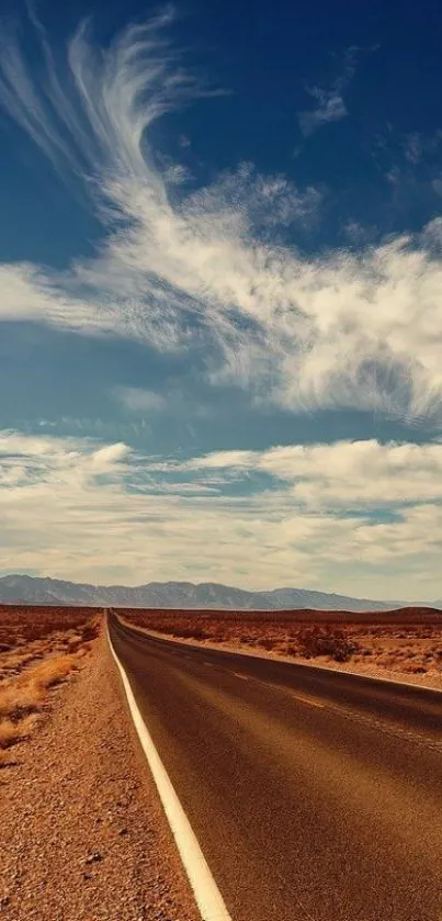 Scenic highway through desert under a blue sky.