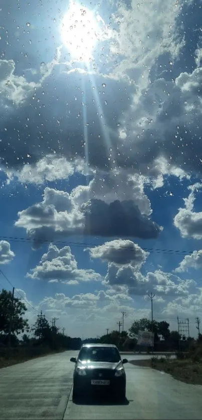 Scenic drive on a sunny road with dramatic clouds overhead.