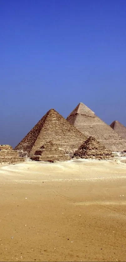 Majestic Egyptian pyramids under a clear blue sky in the desert.