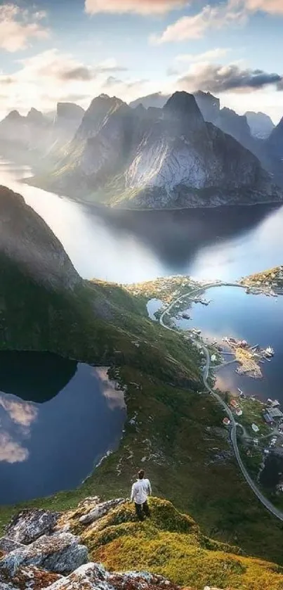 A peaceful view of a fjord with mountains and clear water under a vibrant sky.