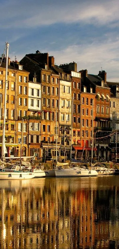 Beautiful reflection of a harbor with sailboats and historic buildings at sunset.