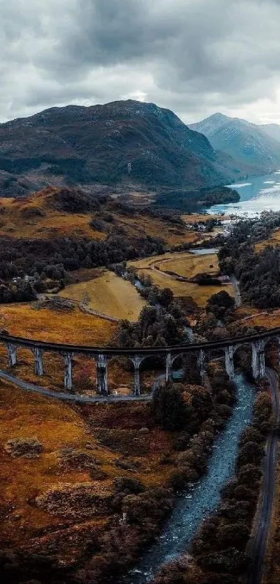 Aerial view of highland viaduct surrounded by mountains and river.