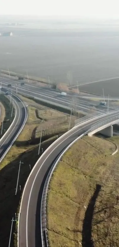 Aerial view of scenic highway interchange with lush landscape.