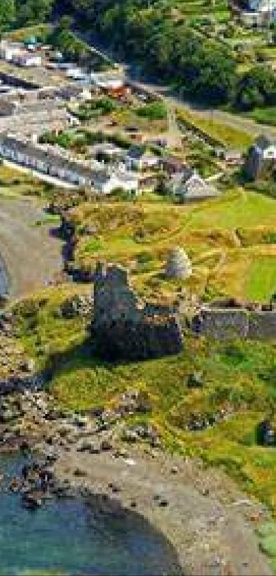 Aerial view of a peaceful coastal village with lush greenery and ruins.