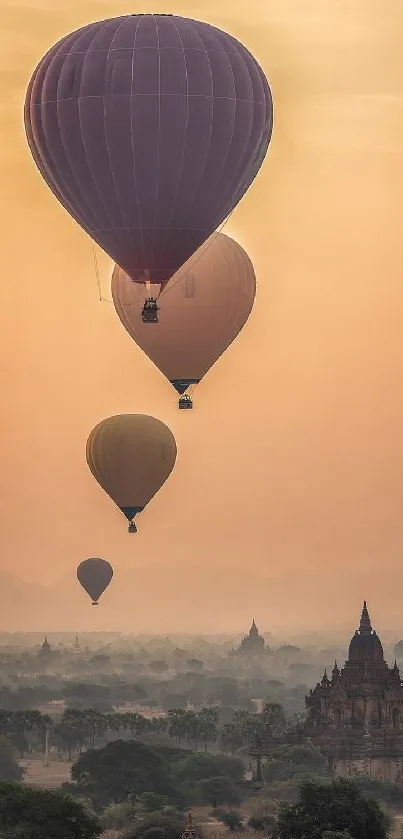 Hot air balloons at sunset over ancient cityscape.