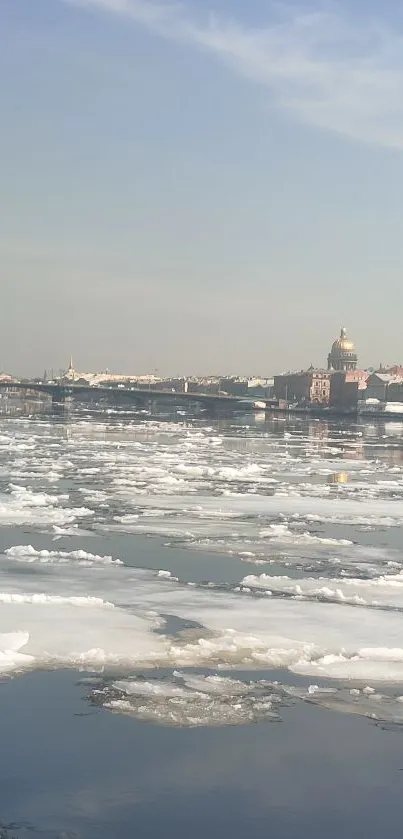 Serene icy river with distant city skyline.