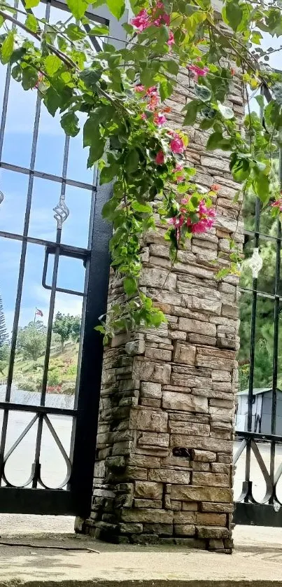 Iron gate with pink flowers and green leaves.