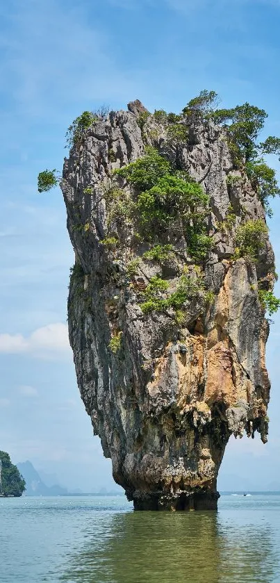 Scenic island rock formation in blue waters and clear sky.