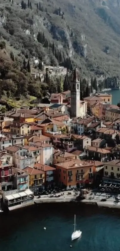 Aerial view of a colorful Italian village by a lake surrounded by hills.