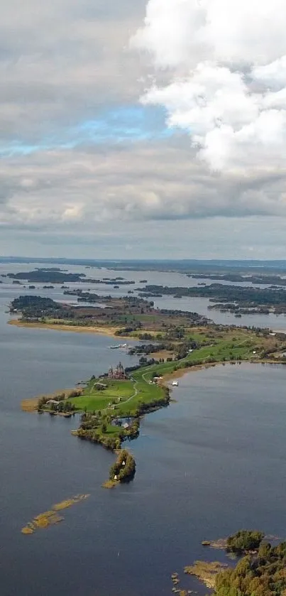 Aerial view of serene lake with green islands under a dramatic cloudy sky.