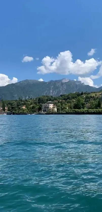 Tranquil lake with mountain backdrop under a blue sky.