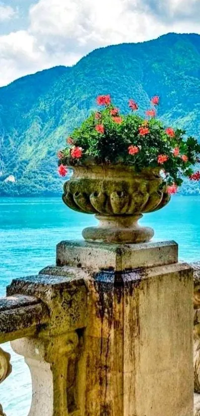 Vibrant floral stone balustrade overlooking a turquoise lake with mountains.