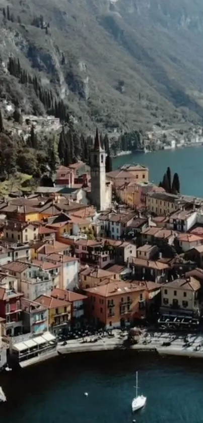 Aerial view of a colorful village by Lake Como with mountains in the background.