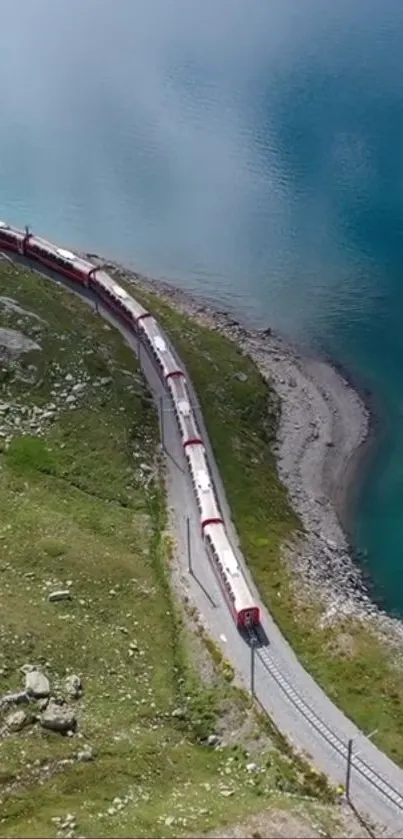 A train passes by a turquoise lake with a scenic mountain view.