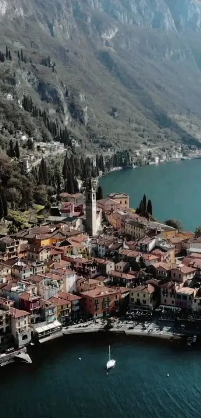 Aerial view of a colorful village nestled by a serene lake and mountains.