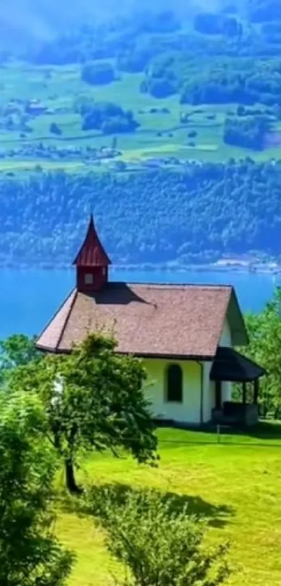 Lakeside chapel surrounded by lush greenery and hills.