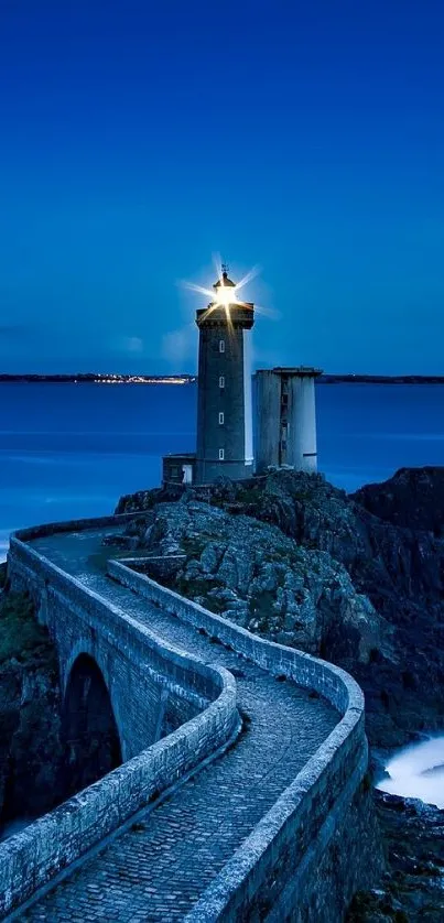 A lighthouse shining over a rocky coastal view at twilight.