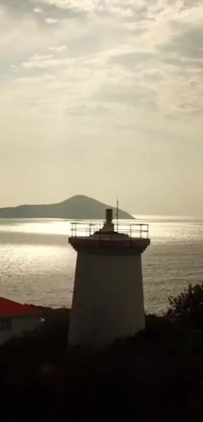 Lighthouse by the calm ocean at dusk.