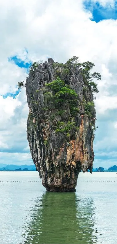 Majestic limestone island with lush greenery in turquoise sea.