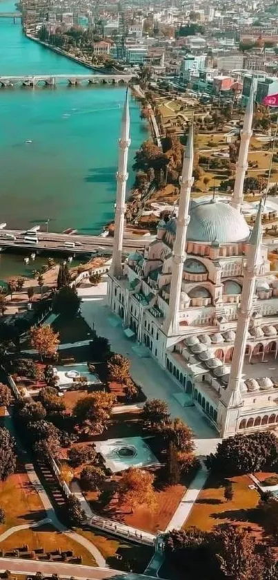 Aerial view of a scenic riverside mosque with cityscape background.