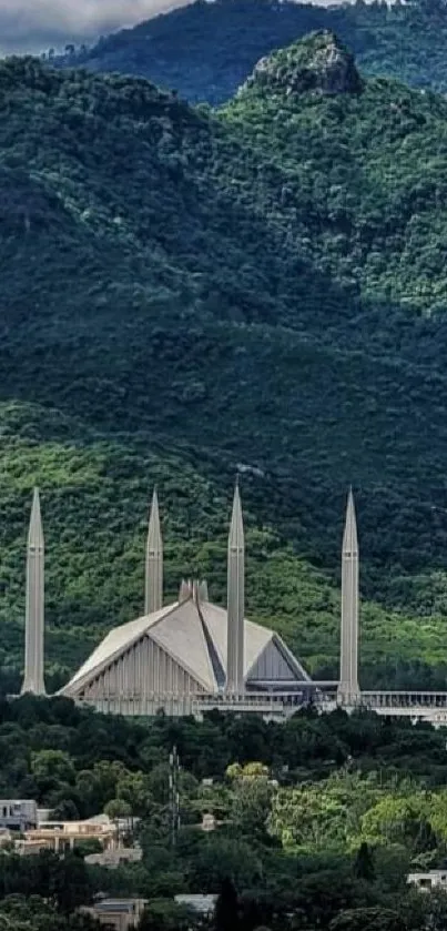 Lush green mountains with mosque in view.