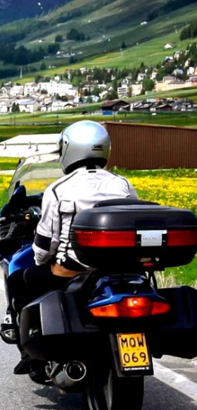 Motorcyclist on scenic road with mountains.