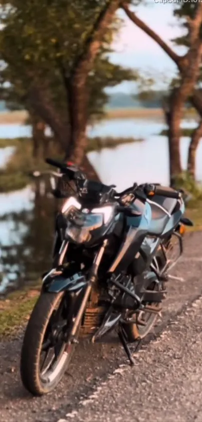 Motorcycle on a scenic, tree-lined road by a river.