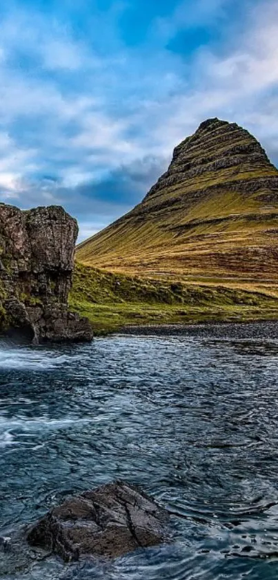 Scenic wallpaper of a mountain and waterfall with a blue sky.