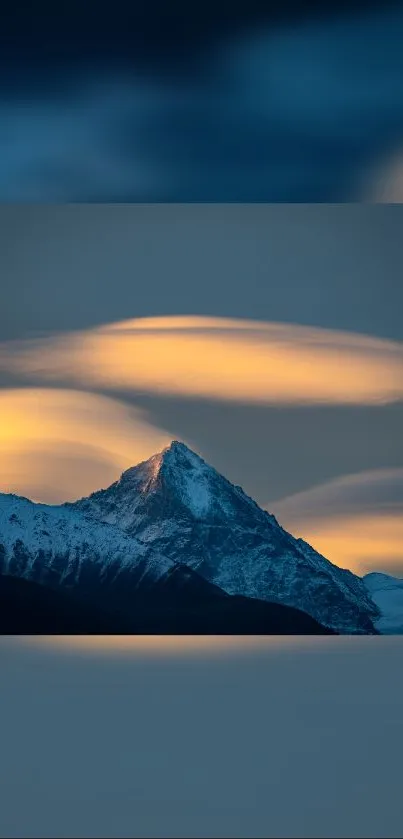 Snow-capped mountain at sunset, with a golden-orange sky, perfect for nature lovers.