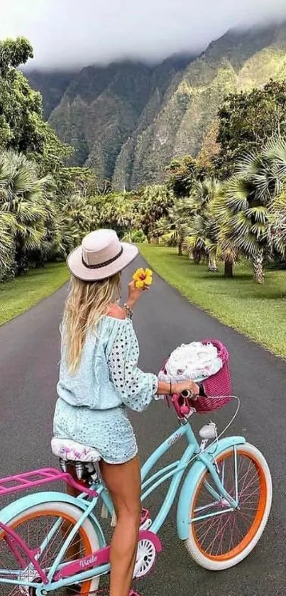 Woman cycling on tropical road with mountain backdrop.