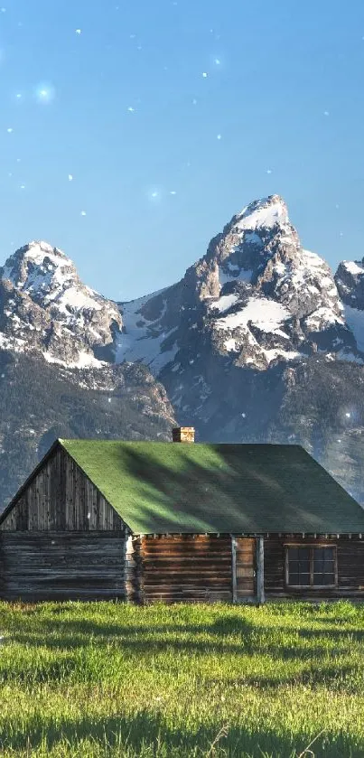 Rustic cabin with mountain backdrop and green field.