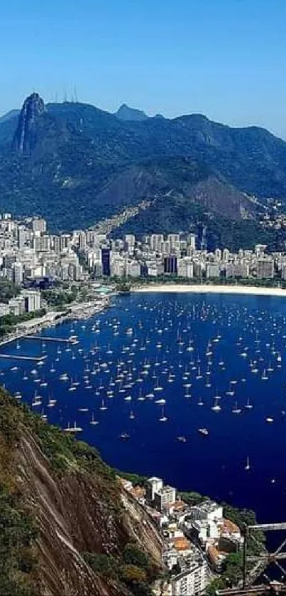 City nestled between mountains and blue bay with boats.