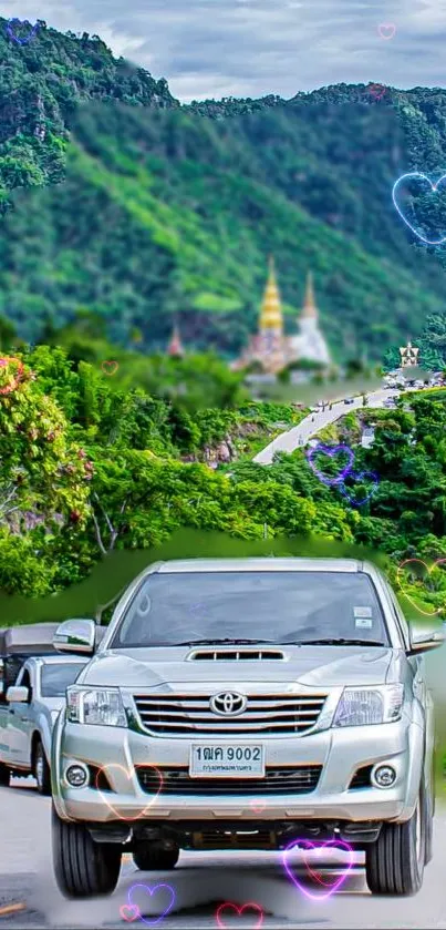 Vehicles on a scenic mountain road with lush greenery and vibrant hearts.