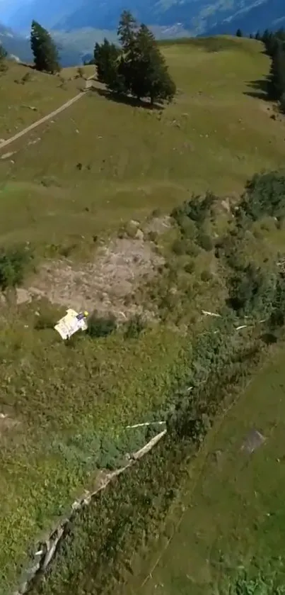 Drone captures serene green hills and mountain landscape.