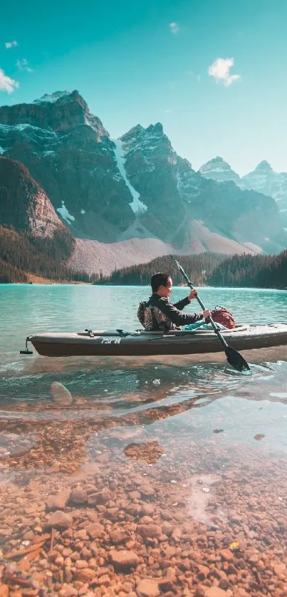 Kayaker on turquoise lake with mountain backdrop.