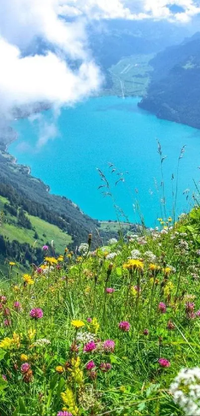 Scenic view of a mountain lake with wildflowers in the foreground and clouds overhead.