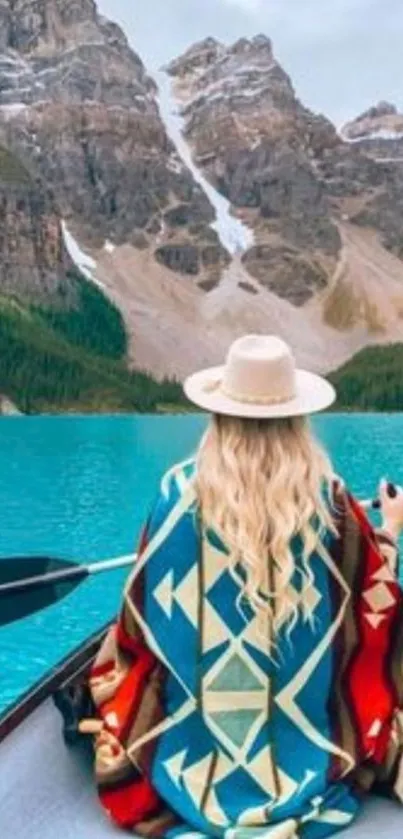 Woman canoeing on blue lake with mountain view.