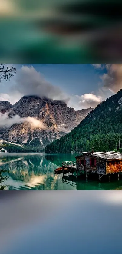 Scenic view of a mountain lake with reflections and a rustic cabin.