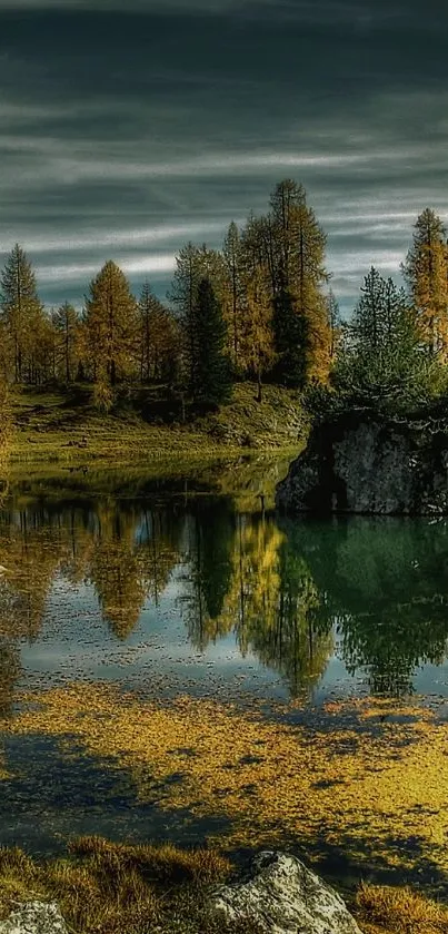 Scenic view of a tranquil lake with autumn trees and distant mountains.