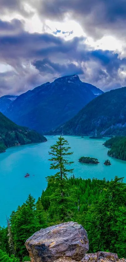 Beautiful mountain lake with lush green forest and dramatic cloudy sky.