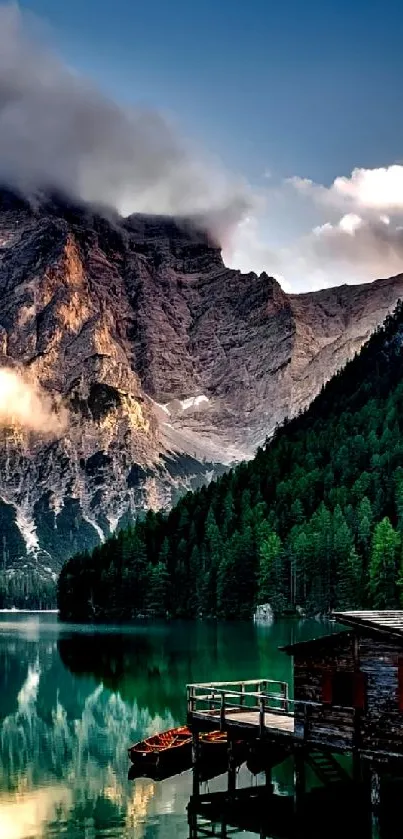 Mountain lake view with forest and dock at sunset.