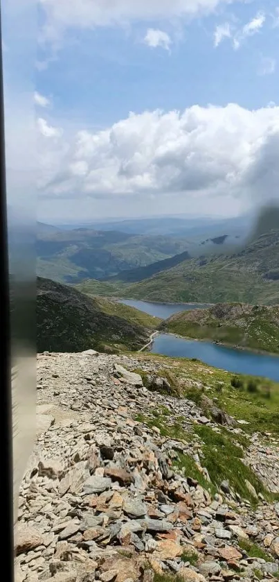 Tranquil mountain lake under a cloudy sky.