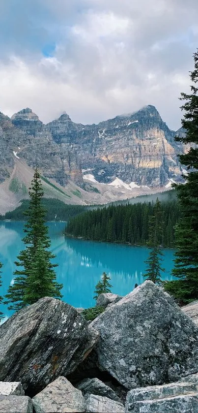 Stunning turquoise lake with mountain backdrop and pine trees.