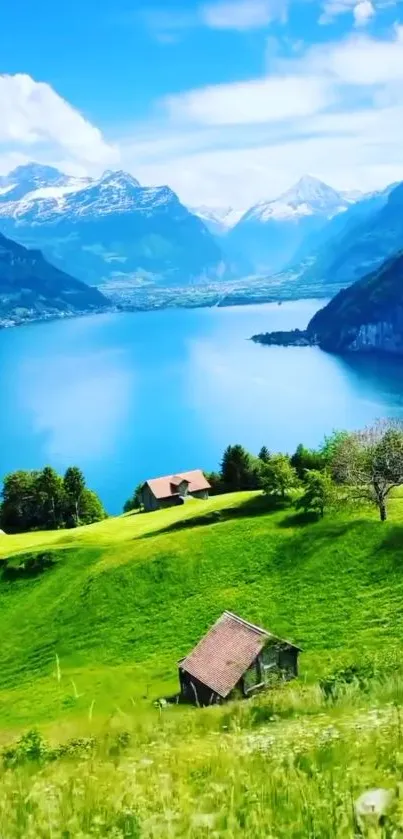 Scenic view of a mountain lake surrounded by green fields and blue skies.