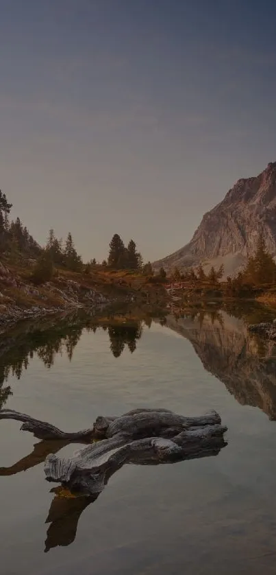 Scenic view of mountain lake at sunset with tranquil reflections.