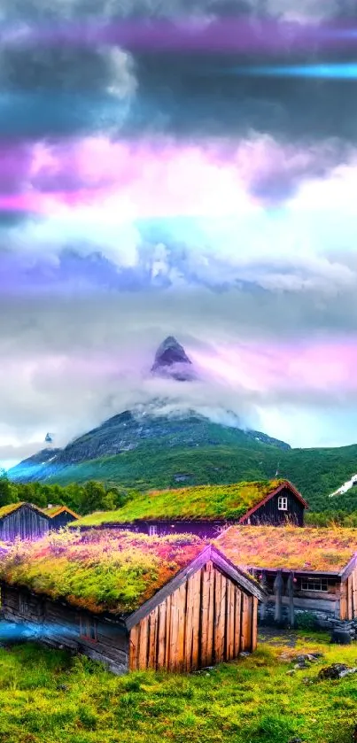 Scenic landscape with mountains, cabins, and a cloudy sky.