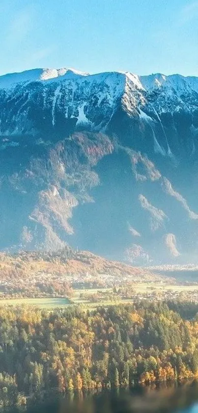 Scenic mountain view with snow-capped peaks and forest.