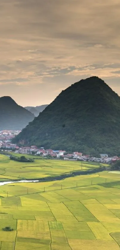 Scenic landscape with mountains and green fields wallpaper.