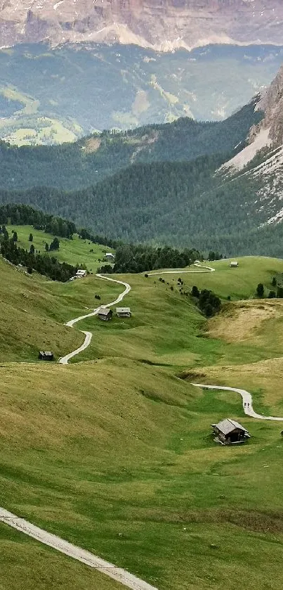 Lush green mountain valley with winding path and scenic views.