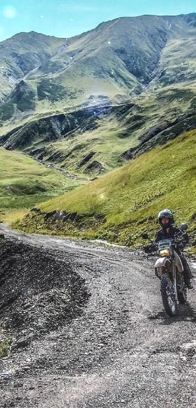 Motorcycle traversing a scenic mountain road with lush greenery.